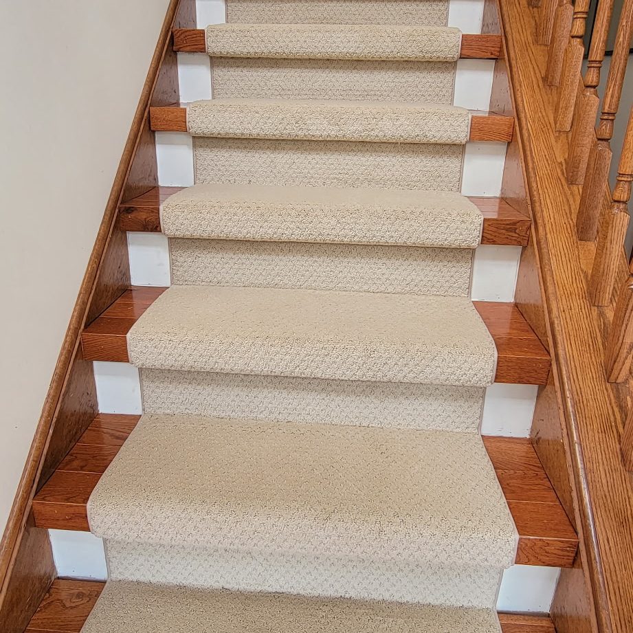beige carpet stair runner over hardwood flooring