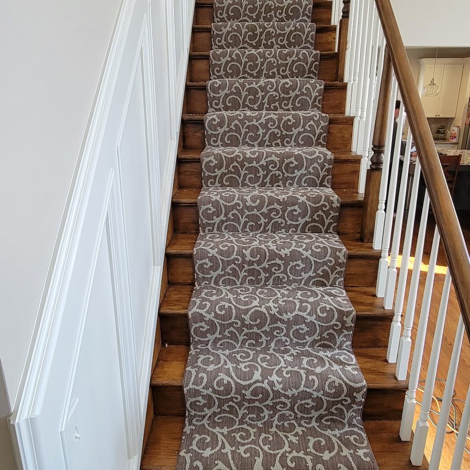 Leopard print carpet stair runner installation over hardwood